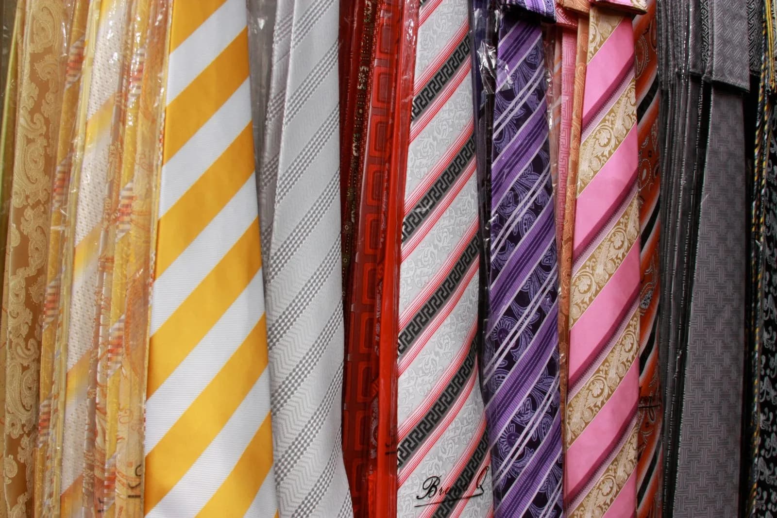 Silk ties in gold, red, purple and pink stripes
