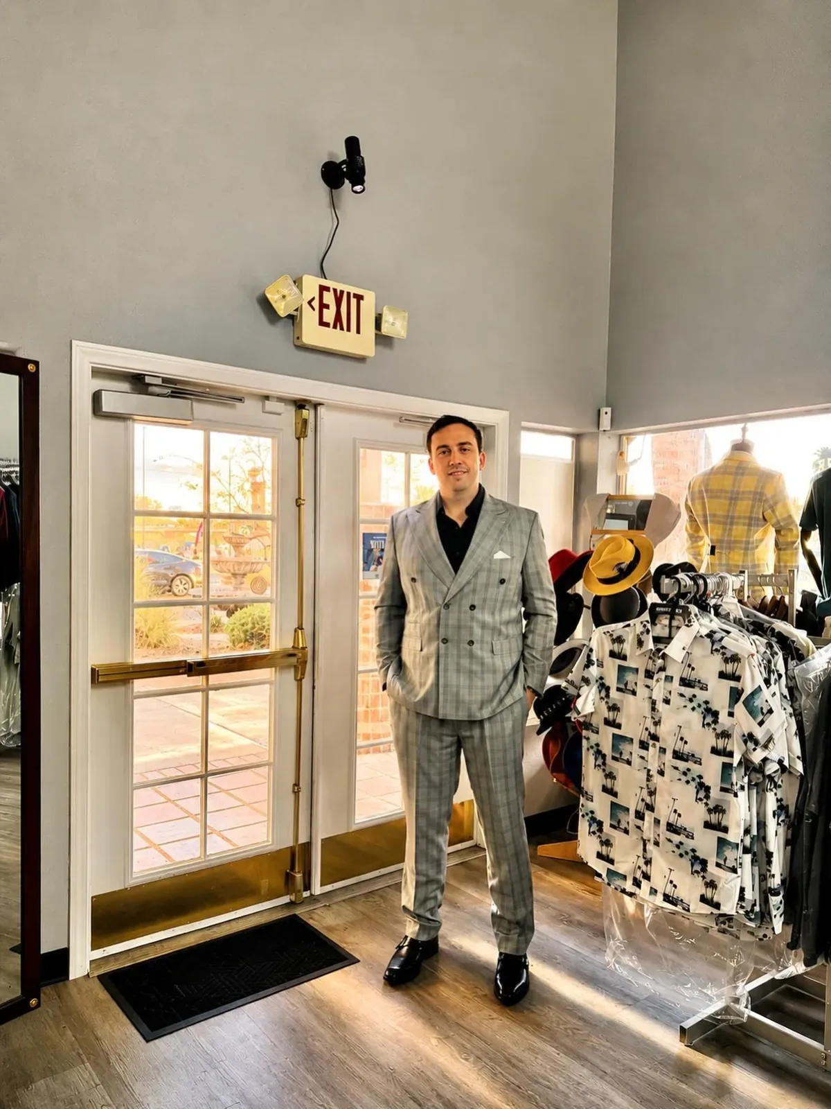 Customer in a grey plaid double-breasted suit at the store entrance